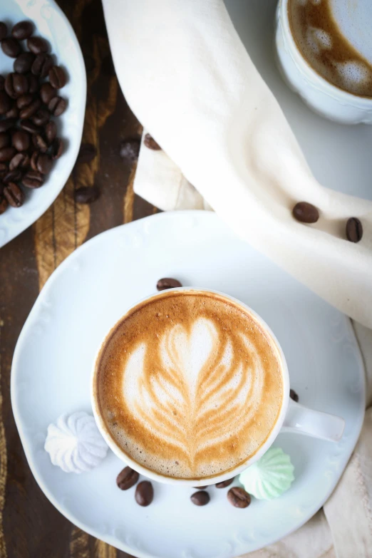 the cappuccino is decorated with a leaf