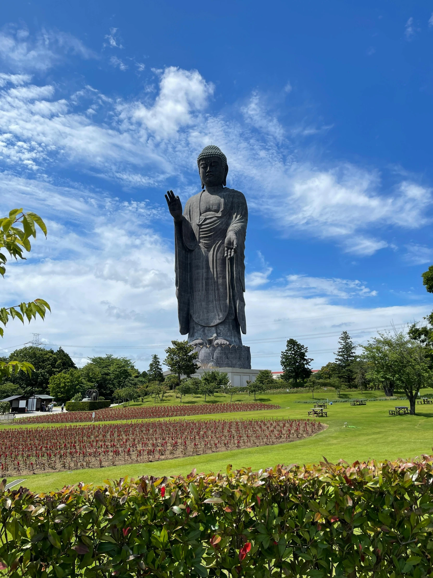 a large statue sitting in the middle of a garden