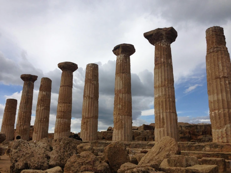 large rocks stacked together with a lot of columns next to it