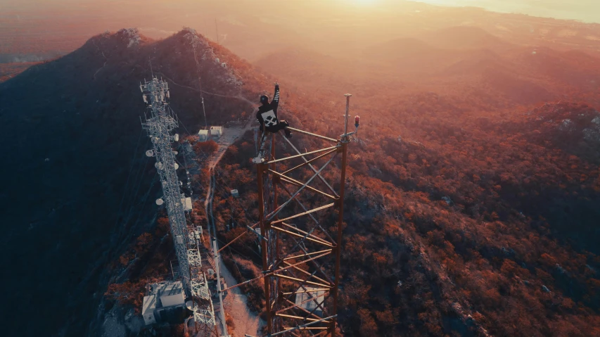 a cell phone tower overlooking the horizon of a valley