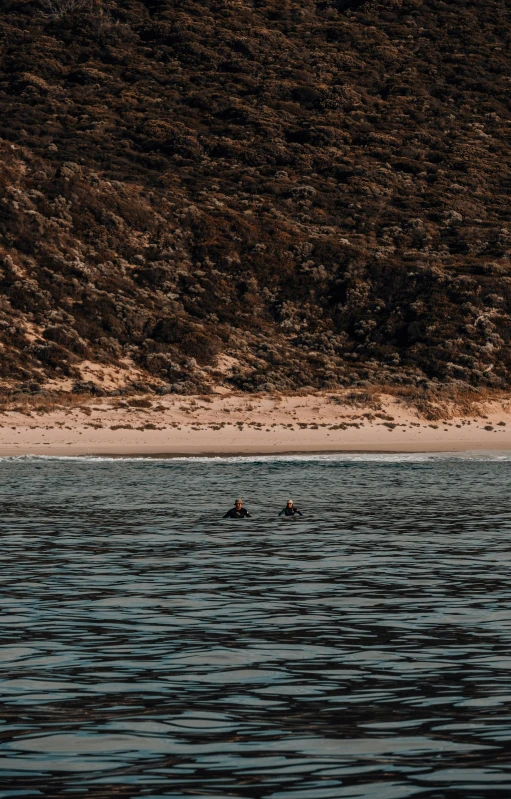 two people are kayaking in the ocean