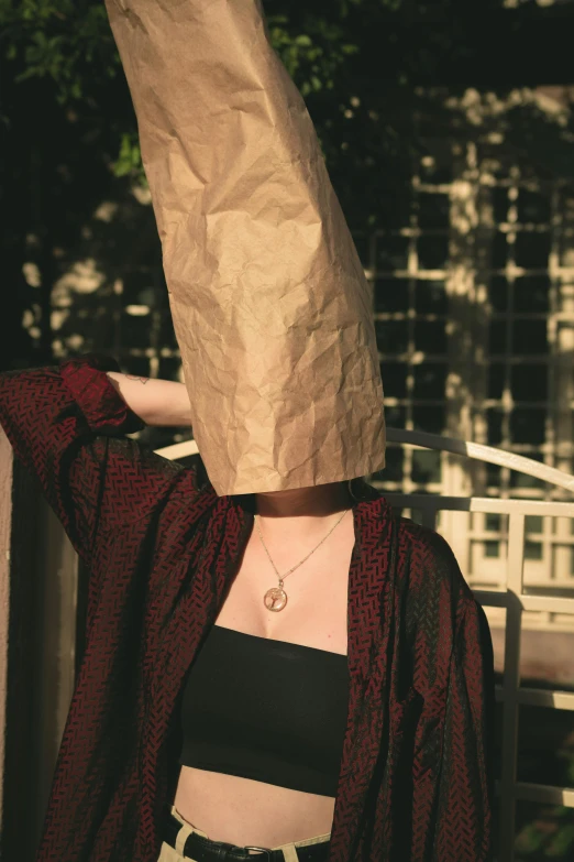 a woman wearing a paper bag on her head