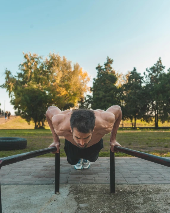 a man on a pair of black shoes doing h up