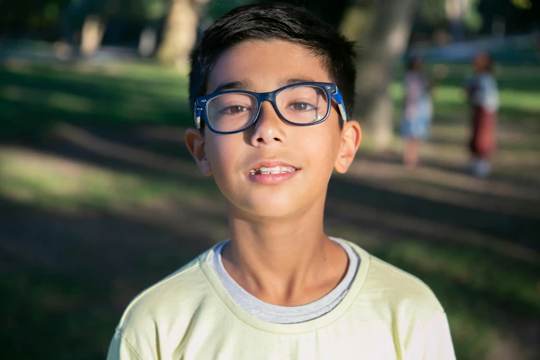 a  with glasses in a park