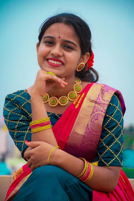 a woman wearing some jewelry and sitting down