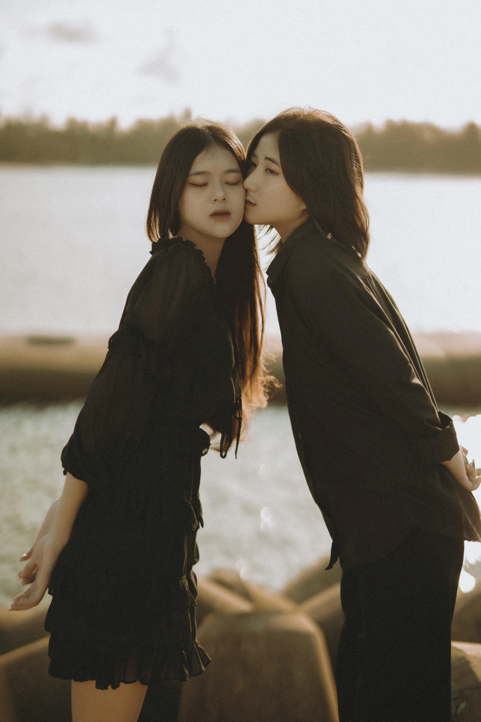 a couple of asian women in short skirt kiss each other