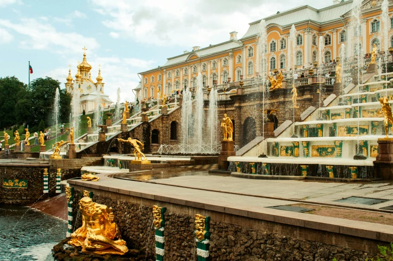 a city with golden statues near some buildings