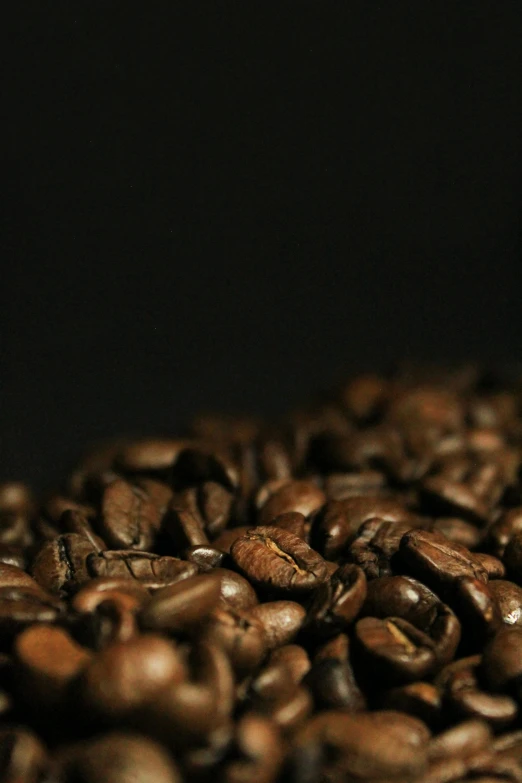 coffee beans falling from the coffee cup are very dark