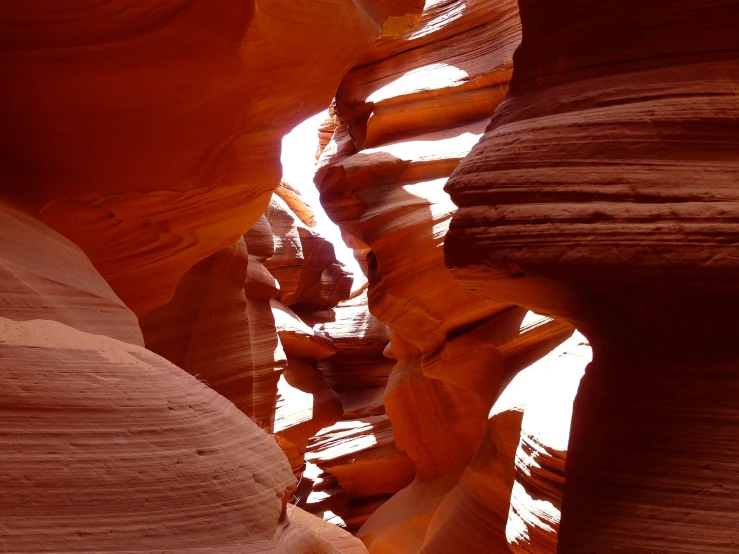 narrow canyon made from stones with sunlight coming through the slots