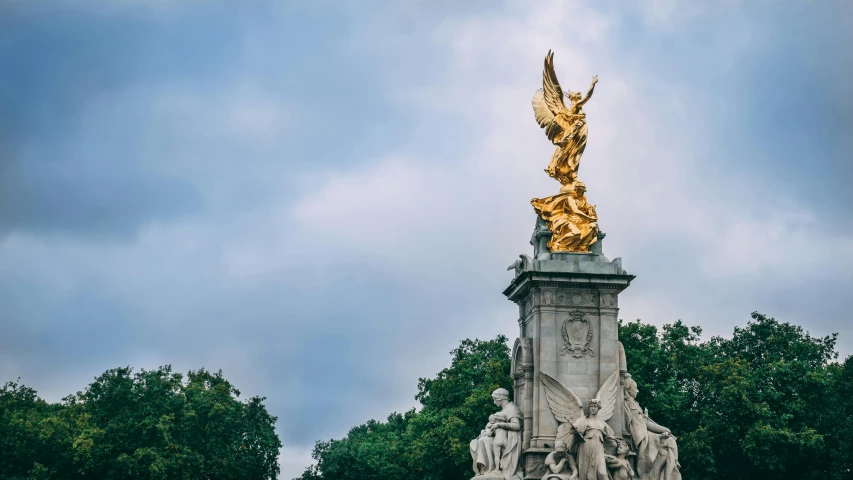 a large golden statue with angel wings at the top