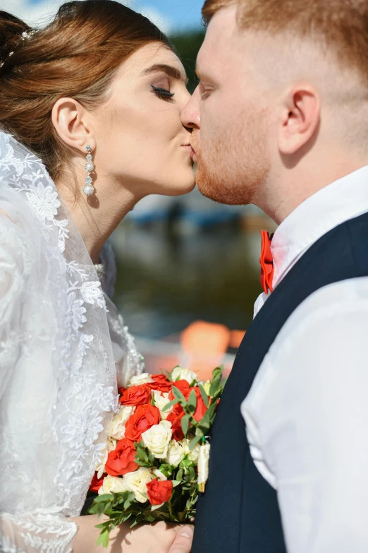 a woman is kissing a man in the face