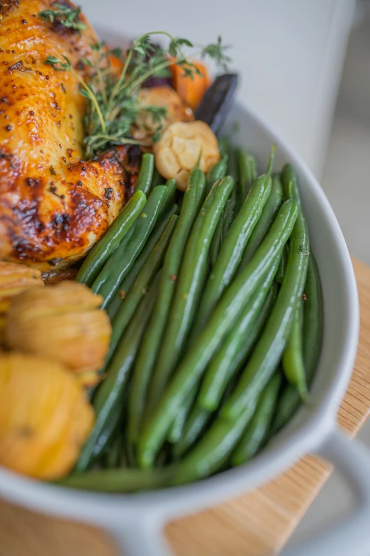 a bowl that is full of food with green beans