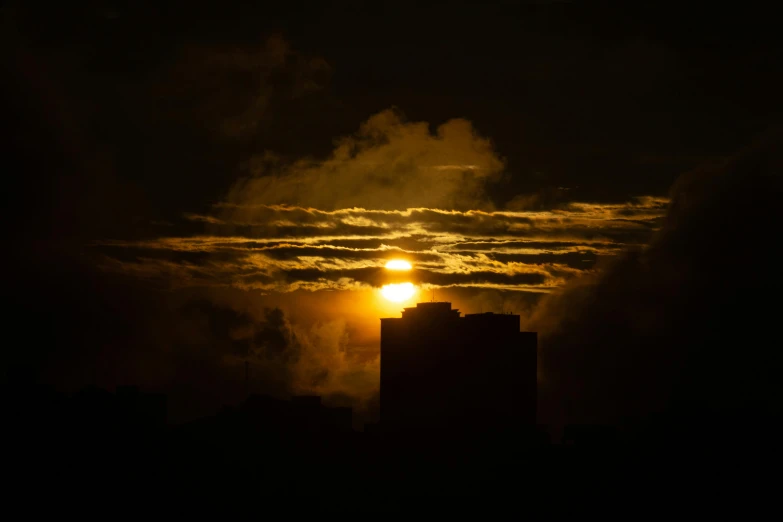 a building near the moon is lit in the dark