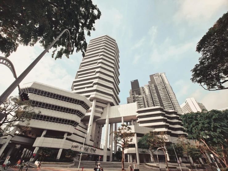 some tall buildings are standing among trees