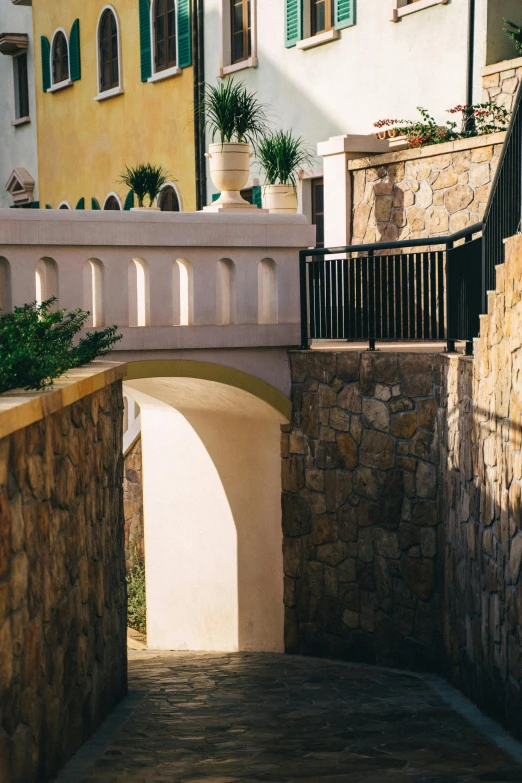 a bridge leading over water between two buildings