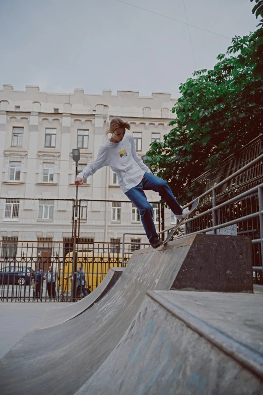 a boy is skateboarding on the top of a ramp