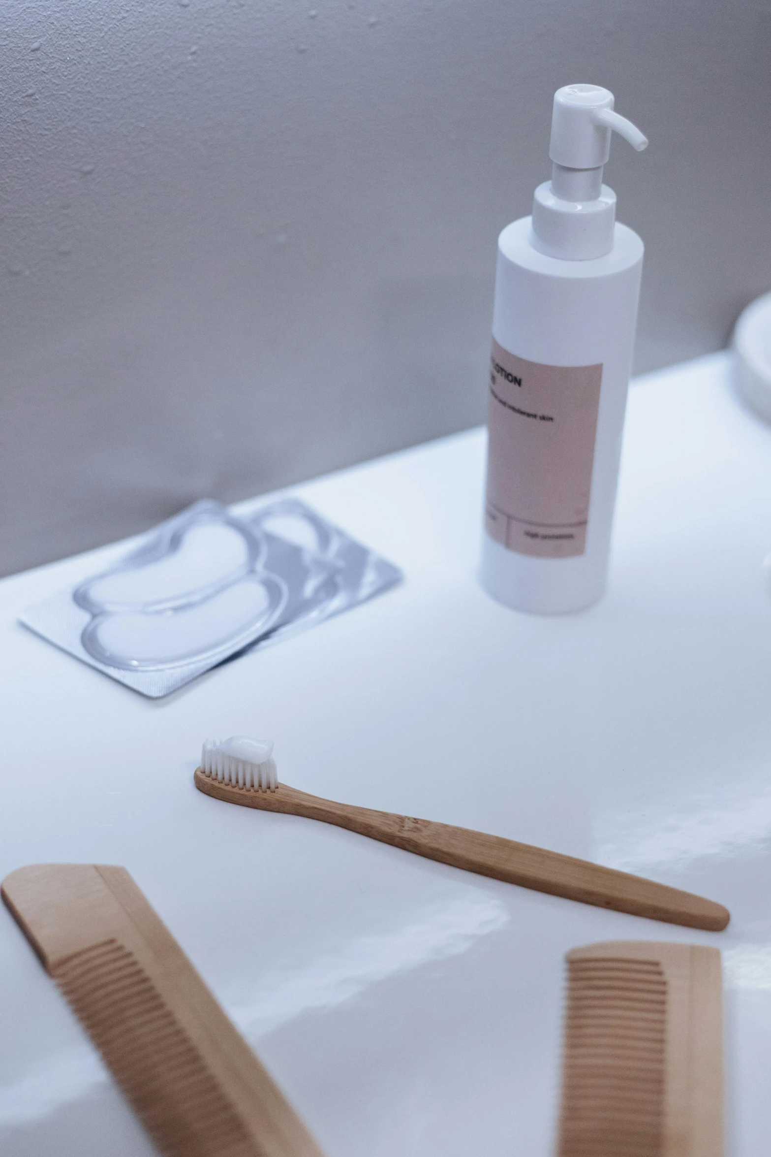 a close up of a toothbrush and tube of soap on a table