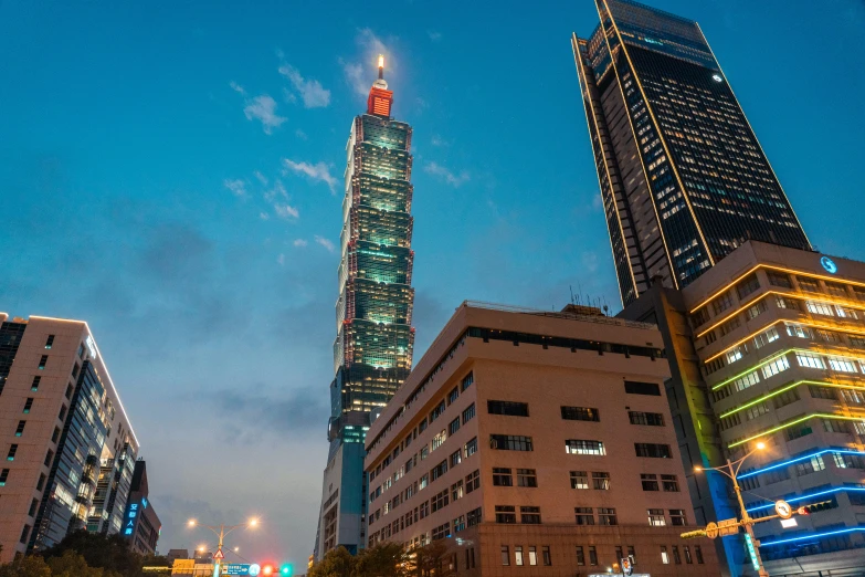 a city skyline at night, with a tower lit up brightly