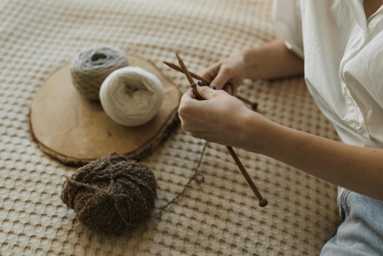 a person sitting on a mat  yarn