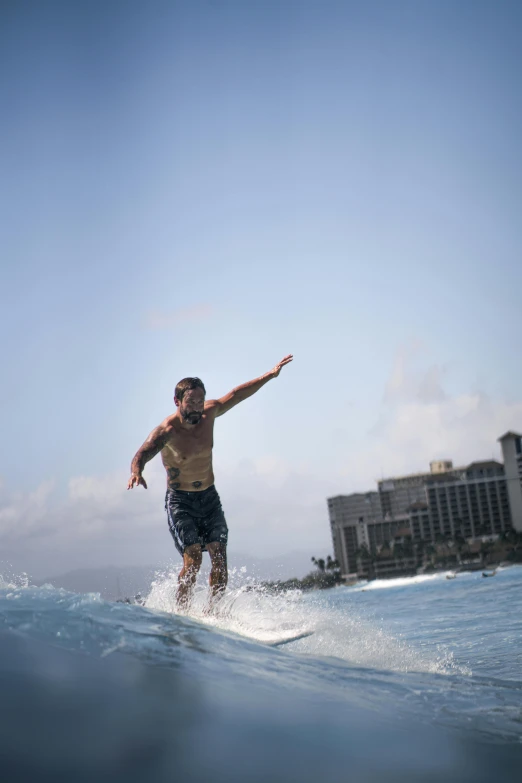 a man surfing in the ocean during the day