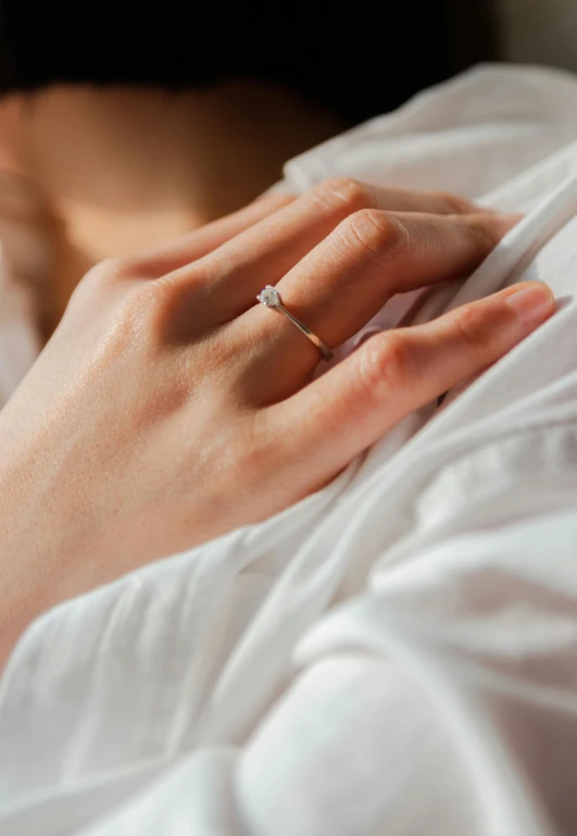 close - up view of person's hand on top of the sheet