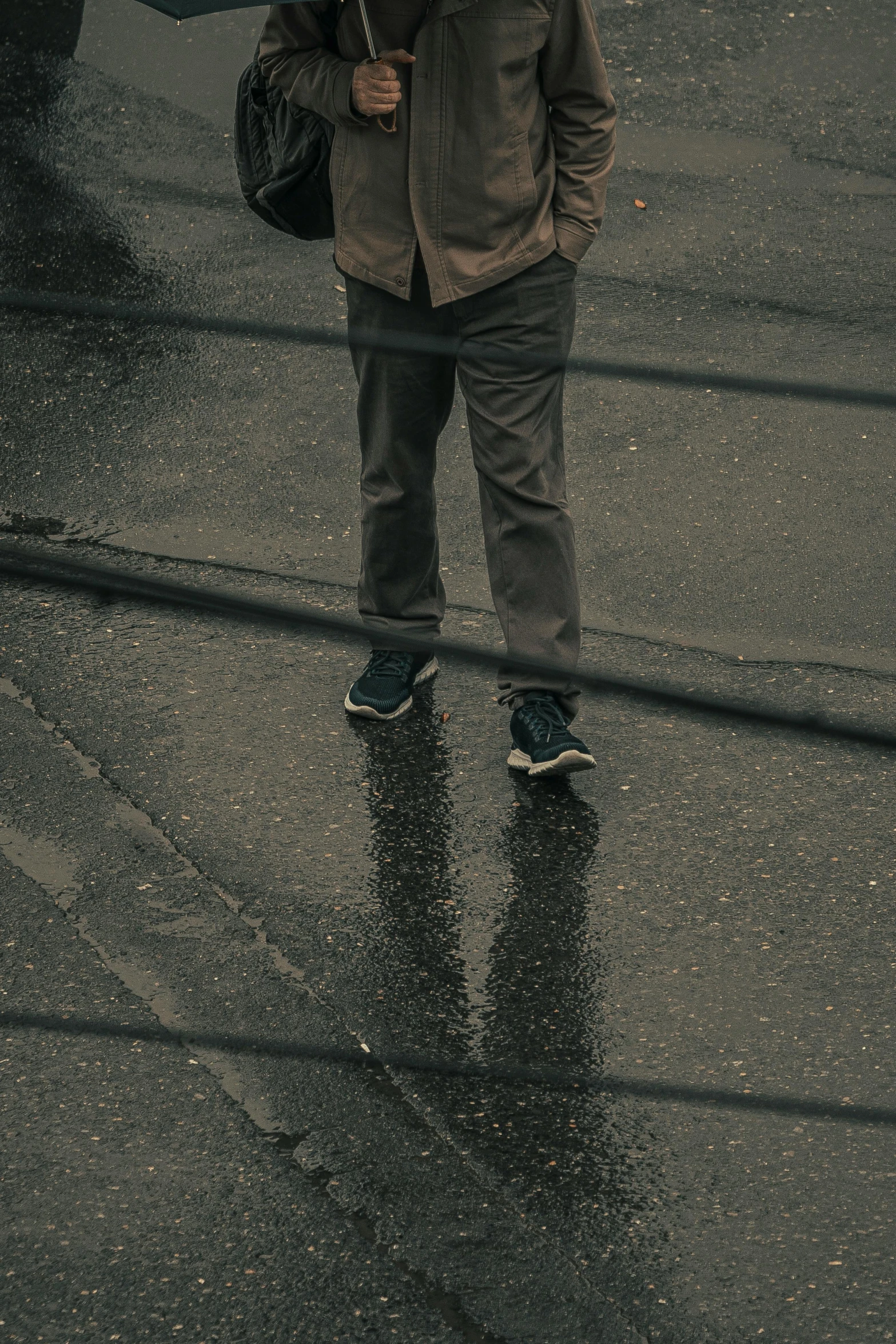 a man with an umbrella standing in the rain