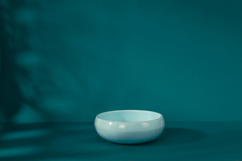 white bowl on a blue table in a room