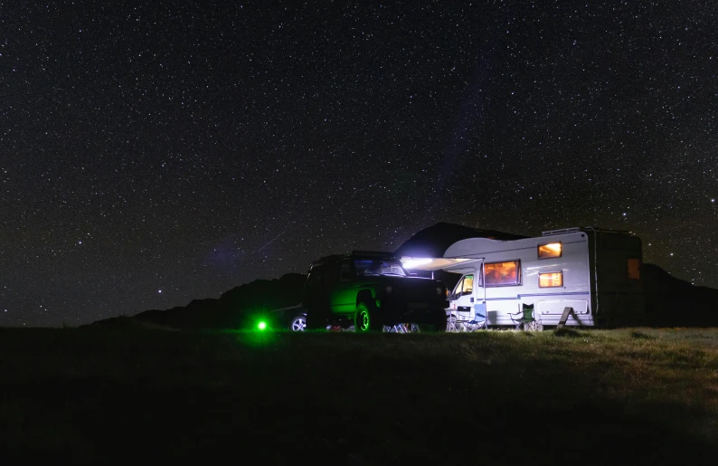 a truck with its lights on driving down a hill