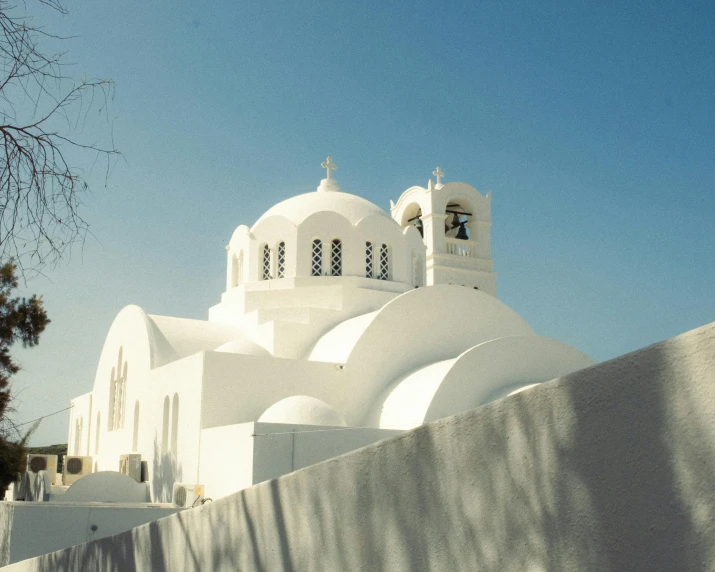 a white building with arched windows on a sunny day