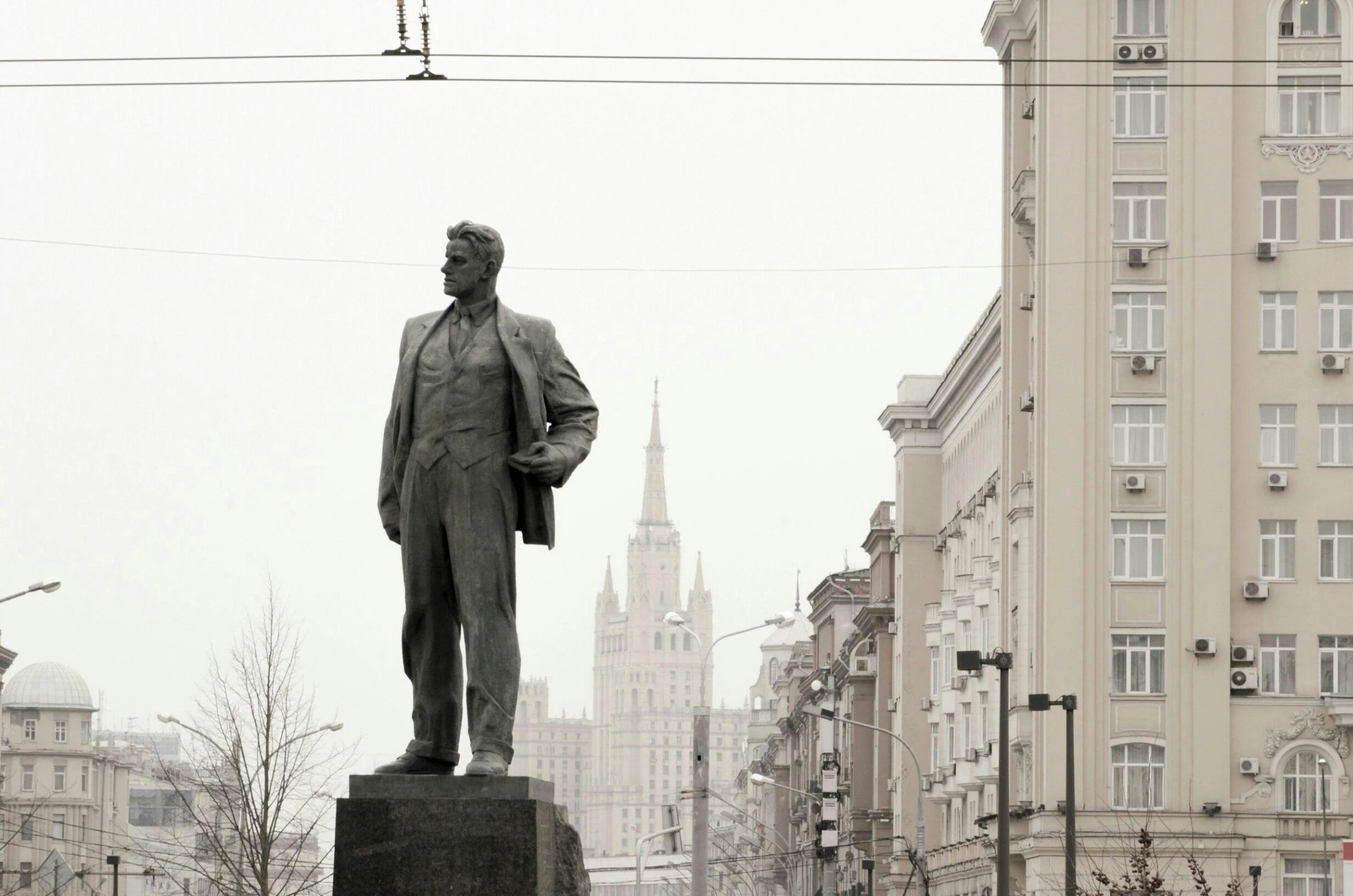 a statue of a man in front of a large building