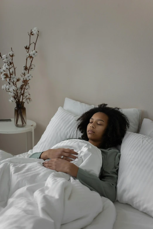 a woman laying on her stomach in bed