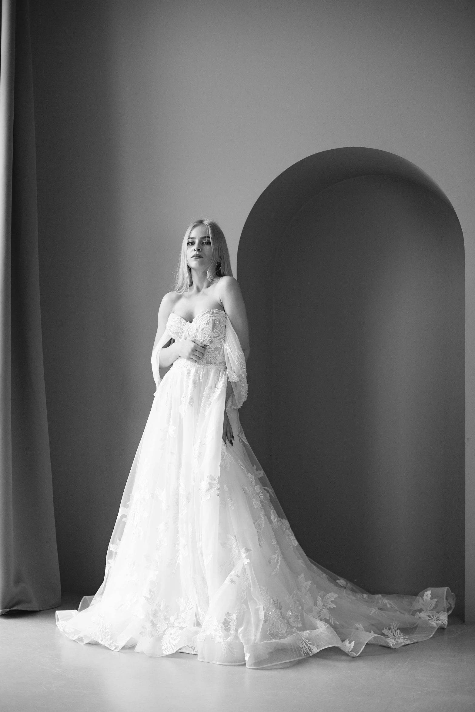 a black and white po of a woman wearing a wedding gown