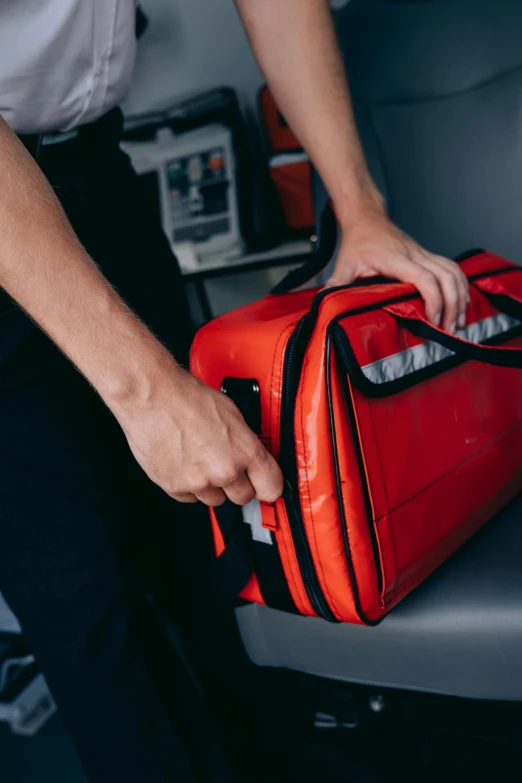 a man putting his luggage in the back of a plane