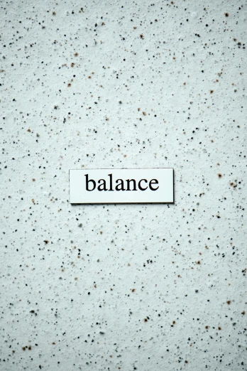 the word balance in a typewriter below a black square