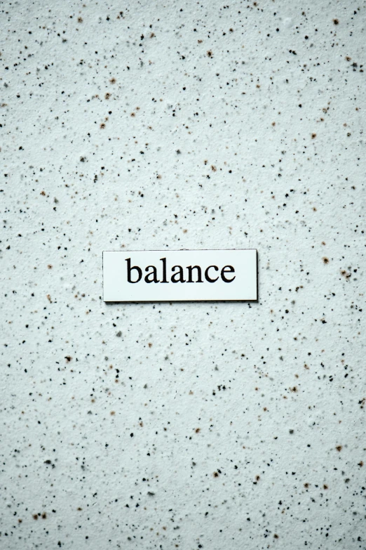 the word balance in a typewriter below a black square