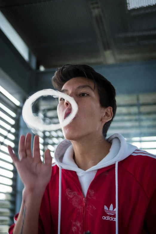 an asian man has his fingers through the bubble