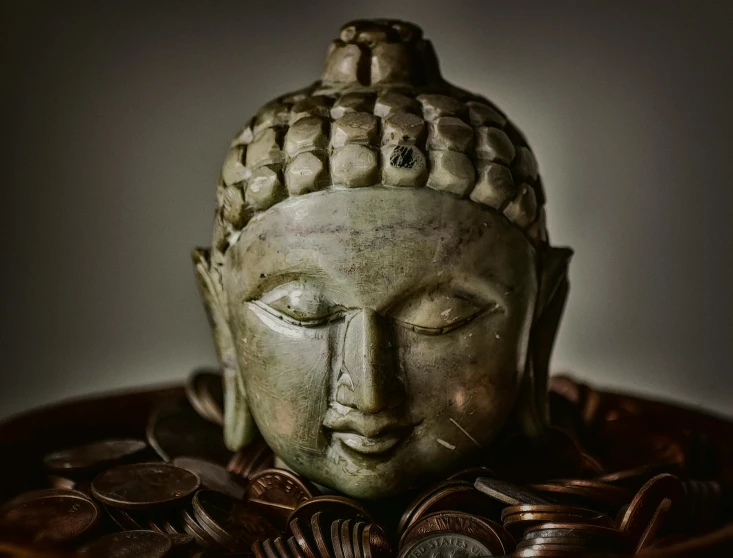 a buddha statue made out of metal and coins