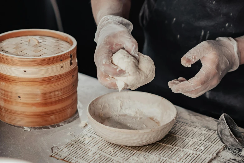 a person wearing protective gloves makes an artisan sauce