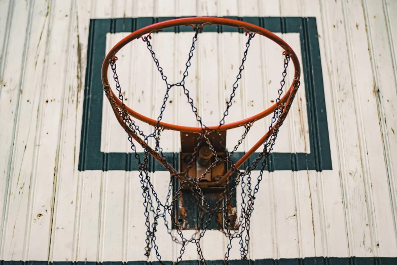 there is a basketball going through a chain - link