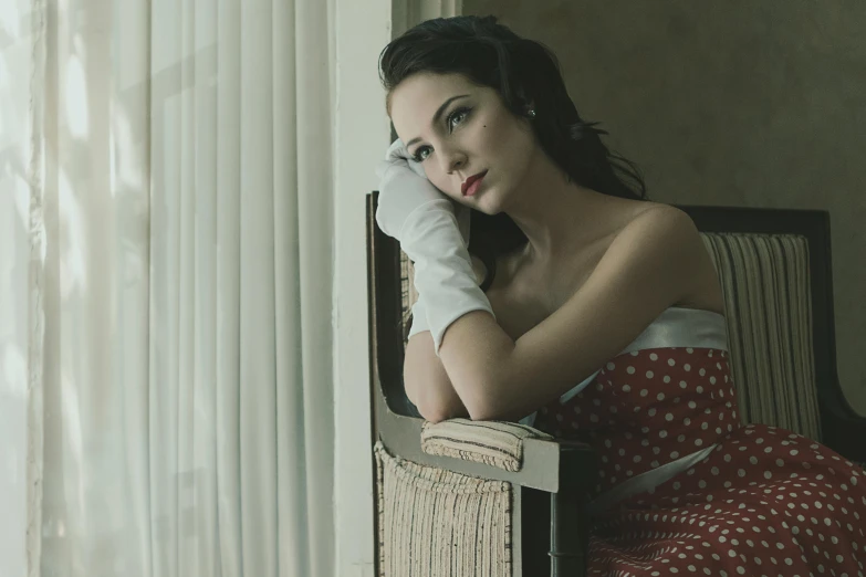 a young woman in a red and white dress holding on to a window