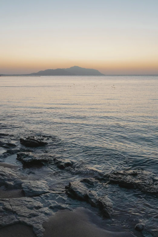 a rocky beach with a body of water