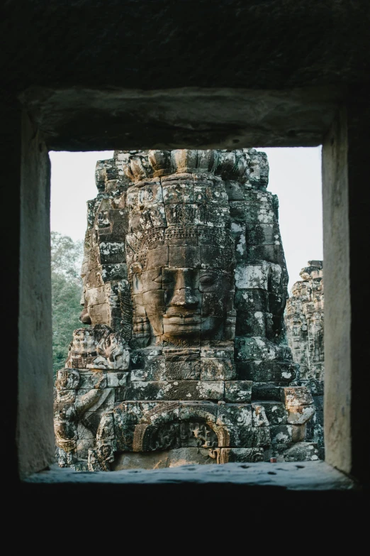 the head of a statue at the entrance to a temple