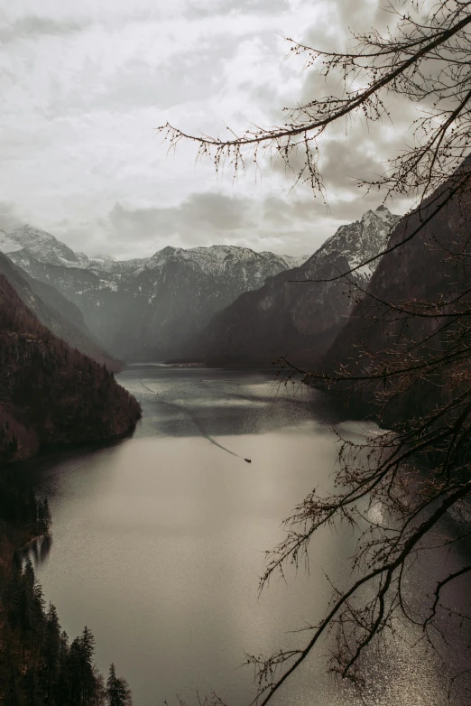 a lake is surrounded by mountains and trees