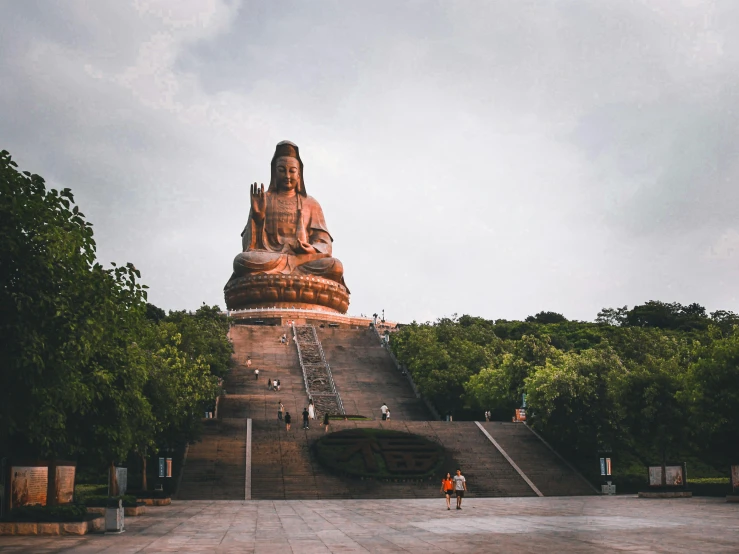 a large buddha statue in front of the steps