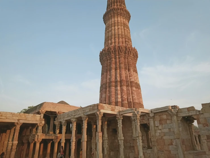 a tall brick building with columns around it