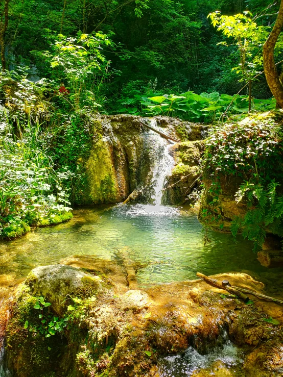 a waterfall that has water running over rocks