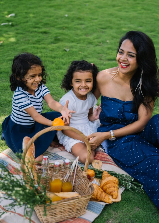 there are three young children having a picnic