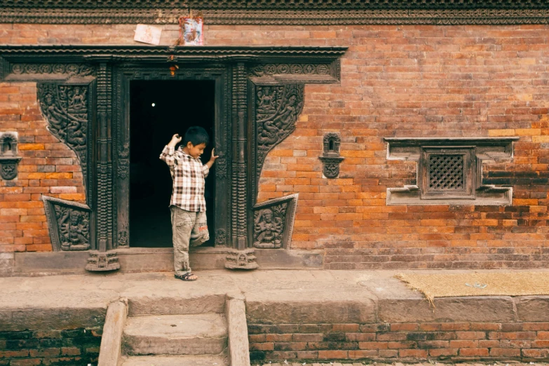 a  holding up soing in front of a doorway