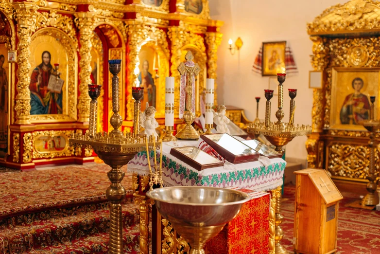 a very pretty golden and red church with candles