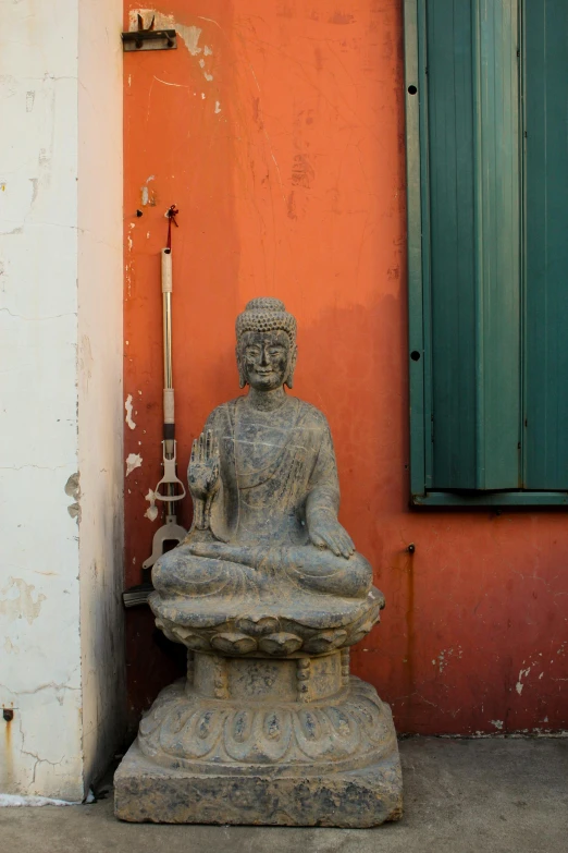 a statue outside a house in front of a building